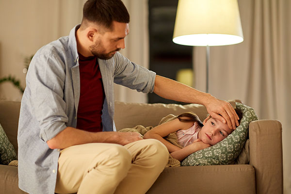 Father checking on his sick daughter.